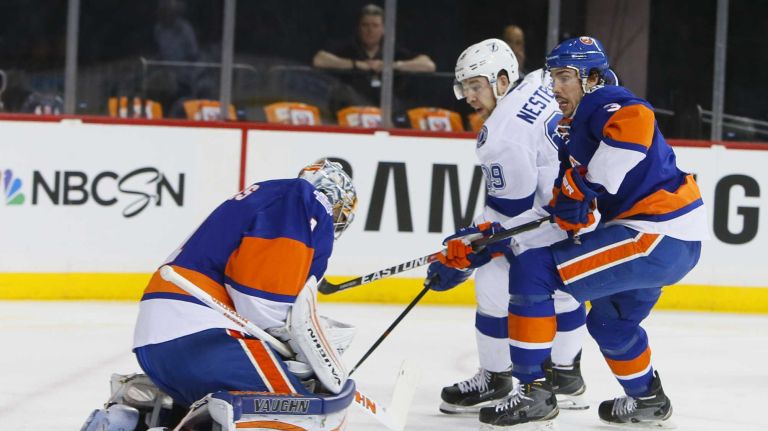 New York Islanders goalie Thomas Greiss (1) makes the save on the shot by Tampa Bay Lightning defenseman Nikita Nesterov (89) as he is defended by New York Islanders defenseman Travis Hamonic (3) in first period in Game 3 of the Eastern Conference semifinals on Tuesday, May 3, 2016 at Barclays Center.