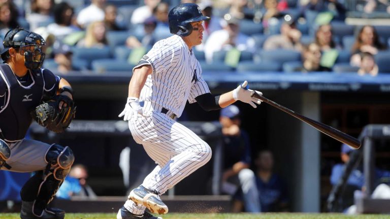 Yankees vs. Rays 111 Jacoby Ellsbury #22 of the New York Yankees follows through on a third inning base hit against the Tampa Bay Rays at Yankee Stadium on Saturday, April 23, 2016 in the Bronx Borough of New York City.