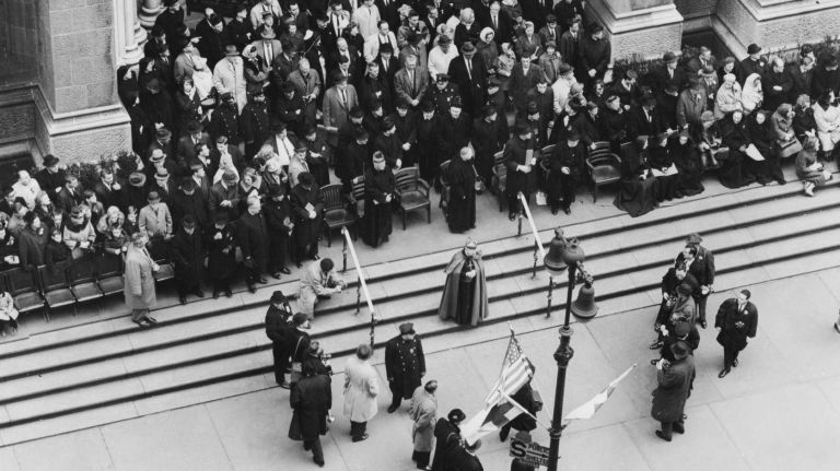 Cardinal Francis Spellman leaves the reviewing stand and descends the steps of St. Patrick's Cathedral to greet a group of marchers in the St. Patrick's Day parade on March 17, 1964.