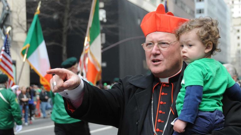 Cardinal Timothy Dolan holds Liam Ort, 1, of Huntington, at the New York City St. Patrick's Day Parade on March 17, 2016.