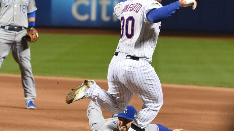 New York Mets left fielder Michael Conforto hits an the RBI single as he beats out Kansas City Royals first baseman Eric Hosmer in the fourth inning during Game 3 of the World Series against the Kansas City Royals at Citi Field on Friday, Oct. 30, 2015.