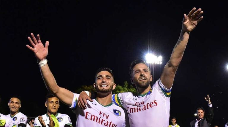Cosmos midfielder Sebastián Ignacio Guenzatti Varela (13) and defender Carlos Mendes (14) salutes their team's fans after defeating New York City FC 1-0 in a U.S. Open Cup game at Jack Coffey Field at Fordham University in Bronx, New York on Wednesday, June 15, 2016.