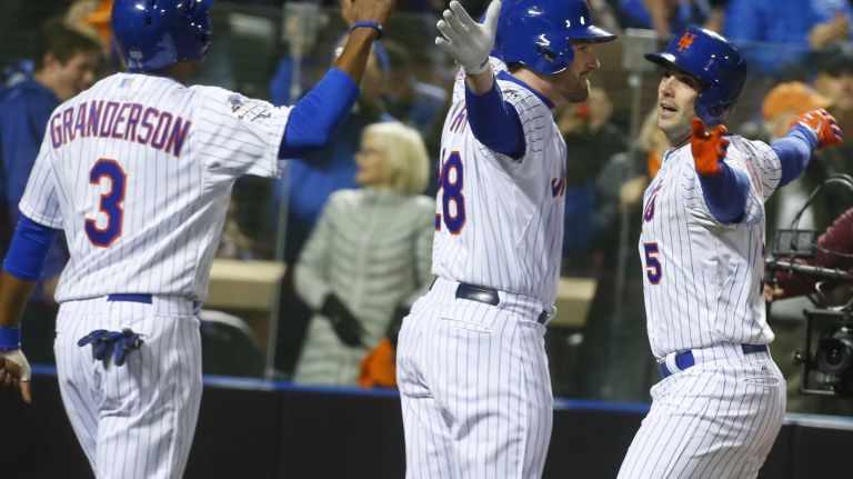 New York Mets third baseman David Wright celebrates his home run with teammates Daniel Murphy (28) and Curtis Granderson (3) during Game 3 of the World Series against the Kansas City Royals at Citi Field on Friday, Oct. 30, 2015.