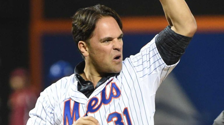 Former Met Mike Piazza pumps his fist as he gets ready to throw out the first pitch before Game 3 of the World Series against the Kansas City Royals at Citi Field on Friday, Oct. 30, 2015.