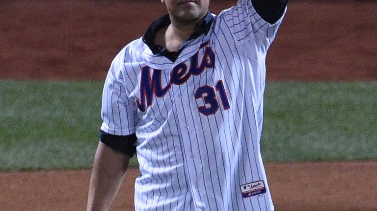 Former New York Mets catcher Mike Piazza waves to the crowd before throwing out the ceremonial first pitch before Game 3 of the World Series between the New York Mets and the Kansas City Royals at Citi Field on Friday, Oct. 30, 2015.