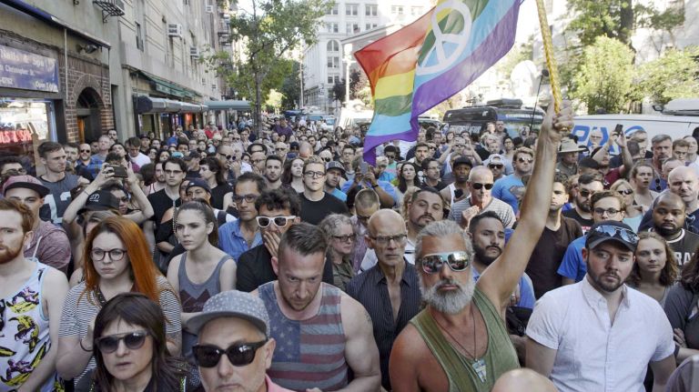 People gather at The Stonewall Inn in Manhattan on Sunday, June 12, 2016, at a vigil for Orlando, Fla., shooting victims. A gunman armed with an assault rifle and handgun killed 49 people and wounded 53 at Pulse, a gay nightclub in Orlando, in what officials termed the worst mass shooting in U.S. history.