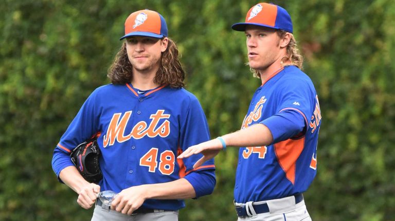 New York Mets starting pitcher Jacob deGrom (48) and New York Mets starting pitcher Noah Syndergaard (34) look on during batting practice during Game 4 of the NLCS against the Chicago Cubs at Wrigley Field on Wednesday, Oct. 21, 2015.