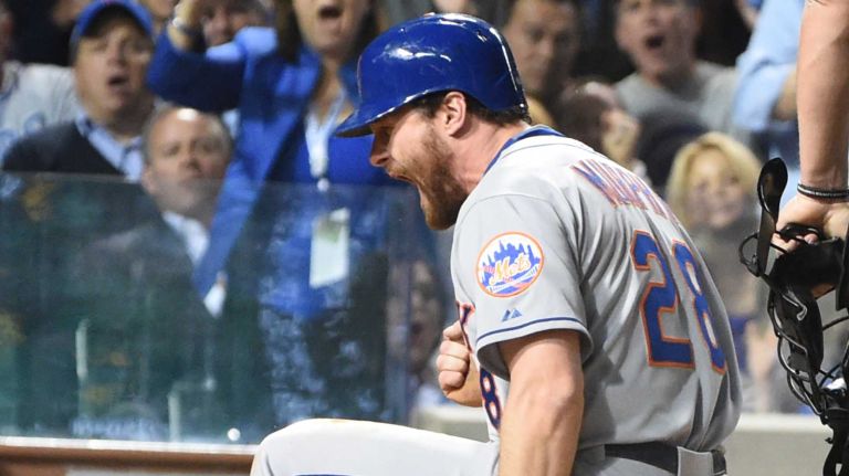 NLCS Game 3: Mets vs. Cubs 43 New York Mets second baseman Daniel Murphy scores and reacts on the ball hit by New York Mets first baseman Lucas Duda as Chicago Cubs catcher Miguel Montero (47) is late with tag in the seventh inning during Game 3 of the NLCS at Wrigley Field on Tuesday, Oct. 20, 2015.