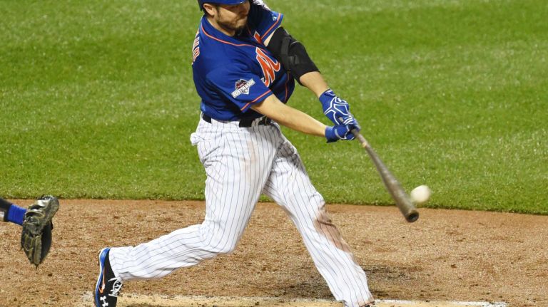 New York Mets catcher Travis d'Arnaud (7) connects on a 3rd inning two-run homer as the Mets vs. Dodgers at Citi Field in Queens during Game 3 of the NLDS on Monday, Oct. 12, 2015.