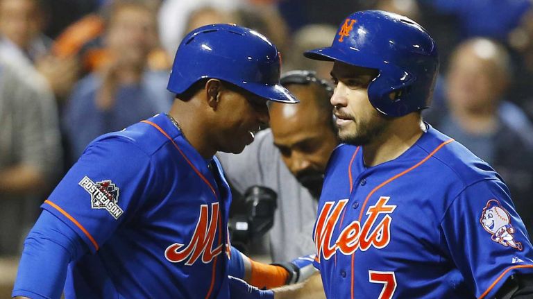 New York Mets centerfielder Yoenis Cespedes (52) waits at home as catcher Travis d'Arnaud (7) greets him after hitting a two-run home run in the third inning of Game 3 of the NLDS against the Los Angeles Dodgers on Monday, Oct. 12, 2015.