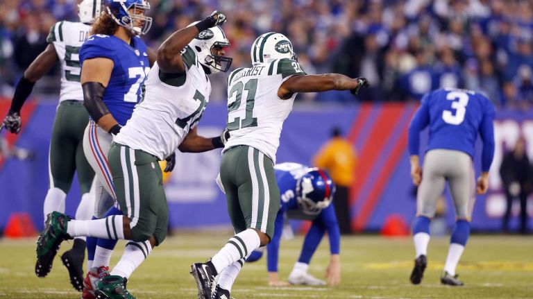 Marcus Gilchrist #21 and Leger Douzable #78 of the New York Jets celebrate after a missed field goal in overtime by Josh Brown #3 of the New York Giants at MetLife Stadium on Dec. 6, 2015 in East Rutherford, N.J.