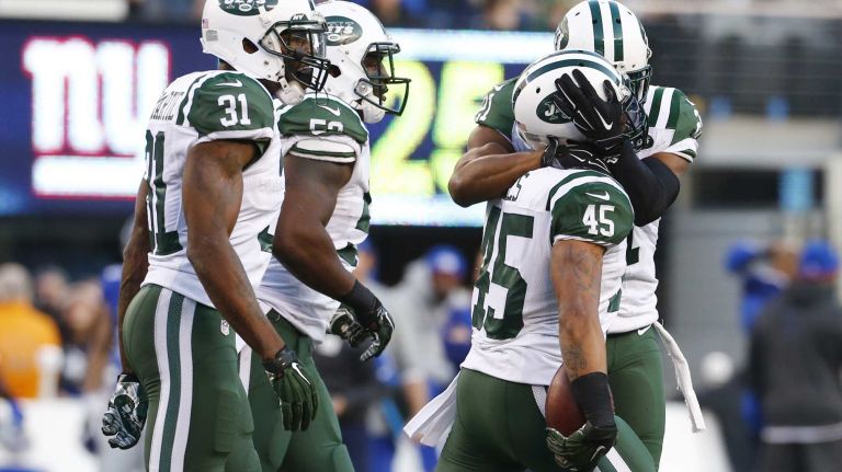 Rontez Miles #45 of the New York Jets is mobbed by his teammates after intercepting the ball in the fourth quarter against the New York Giants at MetLife Stadium on Dec. 6, 2015 in East Rutherford, N.J.