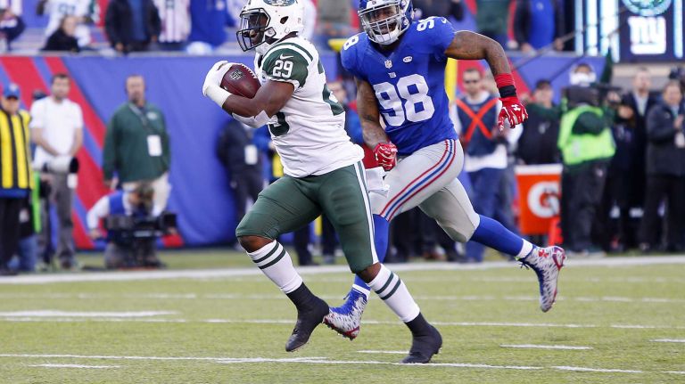 Bilal Powell #29 of the New York Jets runs a reception for a touchdown in the second quarter past Damontre Moore #98 of the New York Giants at MetLife Stadium on Dec. 6, 2015 in East Rutherford, N.J.