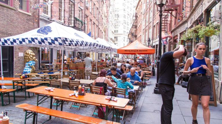 People drink and dine on Stone Street in Manhattan's Financial District on Aug. 20, 2015.