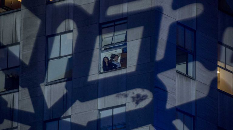 A giant snowflake casts a shadow on a building at the Rockefeller Center Christmas tree lighting ceremony in Manhattan on Dec. 2, 2015.