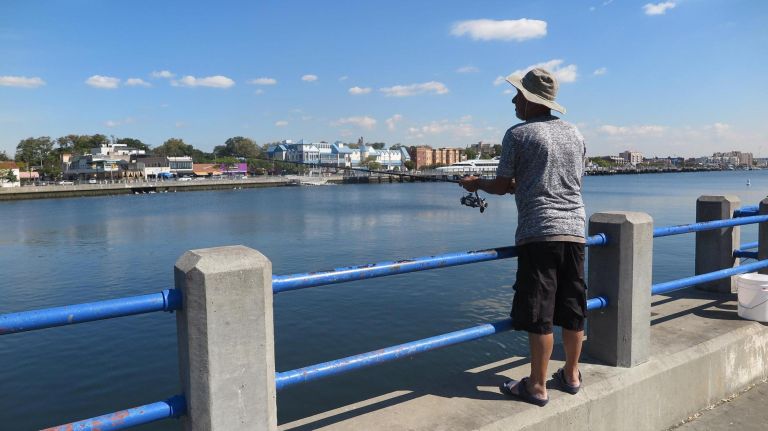 A fisherman tries his luck in the bay.