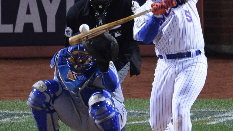New York Mets third baseman David Wright hits a two-run single during Game 3 of the World Series against the Kansas City Royals at Citi Field on Friday, Oct. 30, 2015.