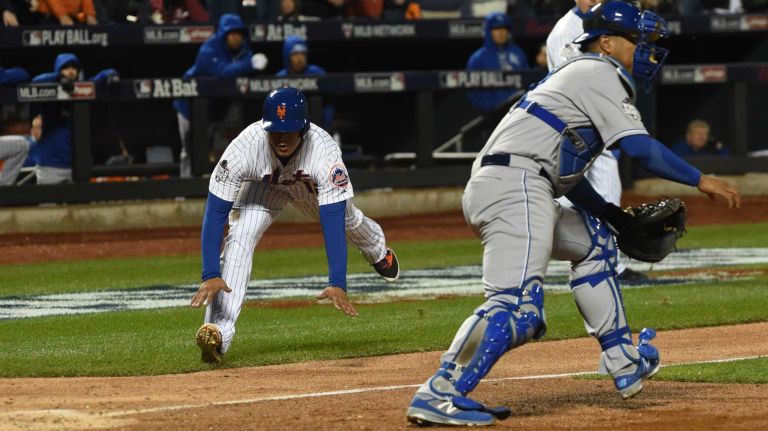 New York Mets center fielder Juan Lagares scores on the hit by Juan Uribe in the sixth inning during Game 3 of the World Series against the Kansas City Royals at Citi Field on Friday, Oct. 30, 2015.