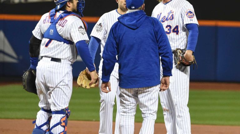 New York Mets pitching coach Dan Warthen (59) comes to the mound to talk with starting pitcher Noah Syndergaard (34) during Game 3 of the World Series against the Kansas City Royals at Citi Field on Friday, Oct. 30, 2015.