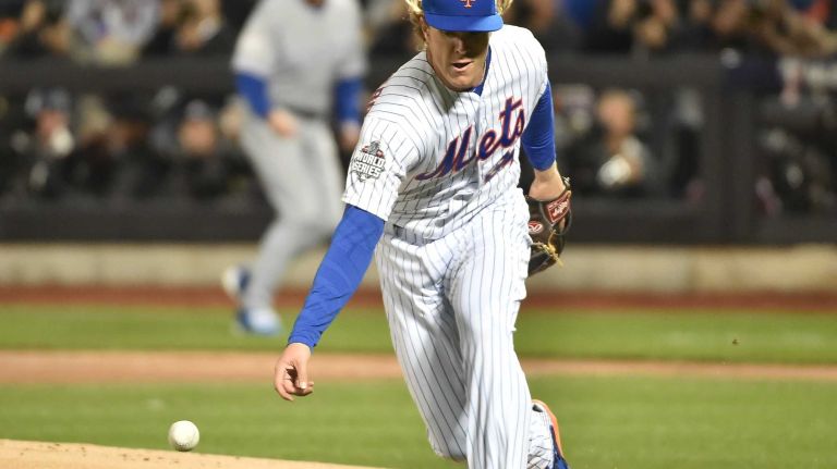 New York Mets starting pitcher Noah Syndergaard (34) tries to field the ball hit by Kansas City Royals first baseman Eric Hosmer (35) in first inning during Game 3 of the World Series against the Kansas City Royals at Citi Field on Friday, Oct. 30, 2015.