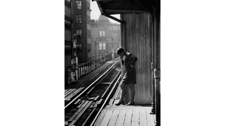 A woman waits on an elevated train platform along the Myrtle Avenue line in Brooklyn. Days later, service was discontinued on the elevated portion of the line, which spanned 35 blocks from Jay Street in Downtown Brooklyn to Broadway in Williamsburg. (Sept. 30, 1969) 