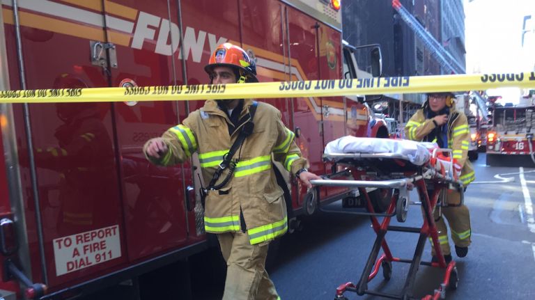 Authorities respond to the scene of a fatal building collapse at 25 W. 38th St.