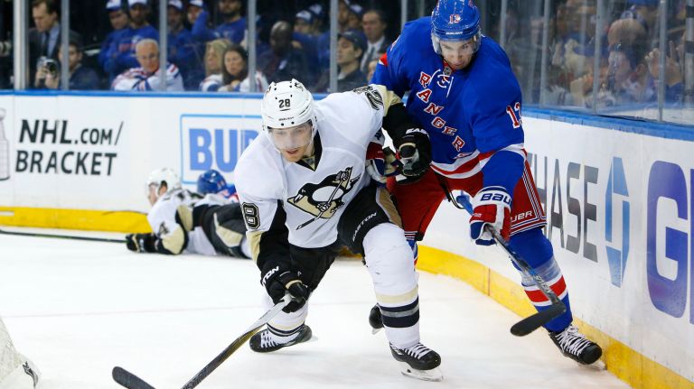 
Ian Cole #28 of the Pittsburgh Penguins battles for the puck in the third period against Kevin Hayes #13 of the New York Rangers at Madison Square Garden on Sunday, Mar. 27, 2016 in New York City. 