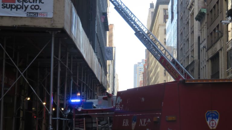 Authorities respond to the scene of a fatal building collapse at 25 W. 38th St.