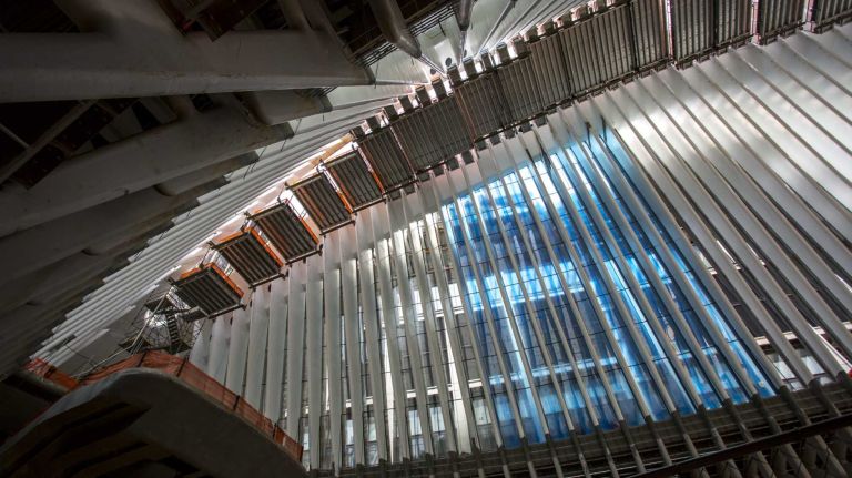 Interior view of the Oculus, framed by white ribs, next to the World Trade Center and 9/11 memorial site on May 6, 2015.