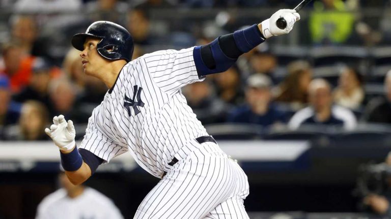 Alex Rodriguez #13 of the New York Yankees follows through on a first-inning home run against the New York Mets at Yankee Stadium on Sunday, April 26, 2015.