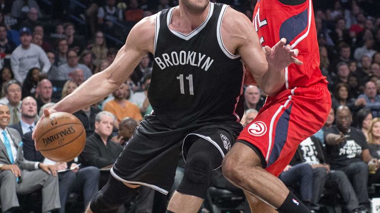 Brooklyn Nets' Brook Lopez drives against Al Horford of the Atlanta Hawks in the fourth quarter during Game 3 of the Eastern Conference quarterfinals at Barclays Center on Saturday, April 25, 2015.