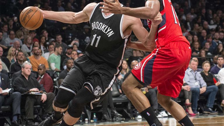 Brooklyn Nets' Brook Lopez drives against Al Horford of the Atlanta Hawks in the fourth quarter during Game 3 of the Eastern Conference quarterfinals at Barclays Center on Saturday, April 25, 2015.