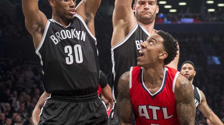 Brooklyn Nets' Thaddeus Young and Brook Lopez double-team Jeff Teague of Atlanta Hawks and force him to pass the ball in the first quarter during Game 3 of the Eastern Conference quarterfinals at Barclays Center on Saturday, April 25, 2015.