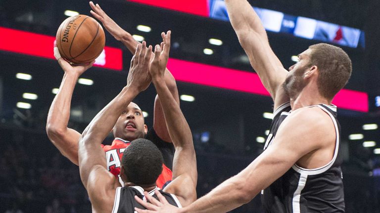 Brooklyn Nets' Thaddeus Young and Brook Lopez double team Atlanta Hawks' Al Horford in the first quarter during Game 3 of the Eastern Conference quarterfinals at Barclays Center on Saturday, April 25, 2015.