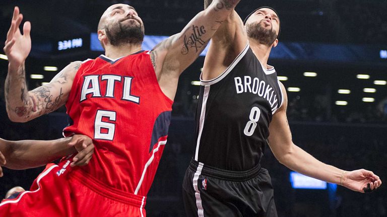 Brooklyn Nets' Deron Williams fights for a rebound against Atlanta Hawks' Alan Anderson in the first quarter during Game 3 of the Eastern Conference quarterfinals at Barclays Center on Saturday, April 25, 2015.