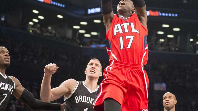 Atlanta Hawks' Dennis Schroder is fouled while driving through the defense of the Brooklyn Nets in the first quarter during Game 3 of the Eastern Conference quarterfinals at Barclays Center on Saturday, April 25, 2015.