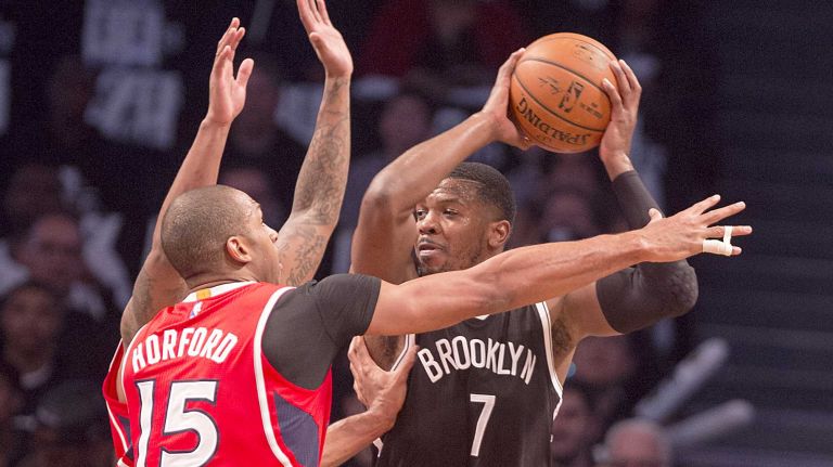 Brooklyn Nets' Joe Johnson is double-teamed by the Atlanta Hawks' Jeff Teague and Al Horford in the first quarter during Game 3 of the Eastern Conference quarterfinals at Barclays Center on Saturday, April 25, 2015.