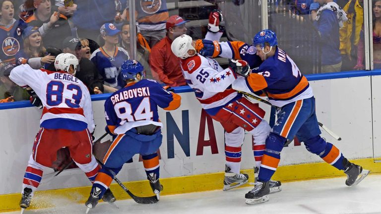Eastern Conference quarterfinals Game 6: Islanders vs. Capitals 60 New York Islanders' Scott Mayfield hits Washington Capitals Jason Chimera against the boards in the third period during Game 6 of the Eastern Conference quarterfinals at Nassau Coliseum on Saturday, April 25, 2015.