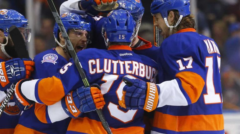 Eastern Conference quarterfinals Game 6: Islanders vs. Capitals 61 Cal Clutterbuck of the New York Islanders celebrates his third-period empty-net goal against the Washington Capitals with his teammates during Game 6 of the Eastern Conference quarterfinals at Nassau Coliseum on Saturday, April 25, 2015.
