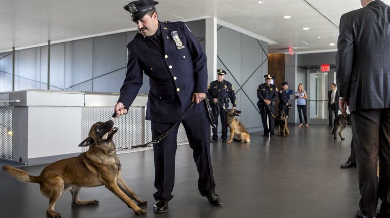 An NYPD officer handles a canine graduate at the New York City Police Academy in Queens on Tuesday, Oct. 6, 2015. 