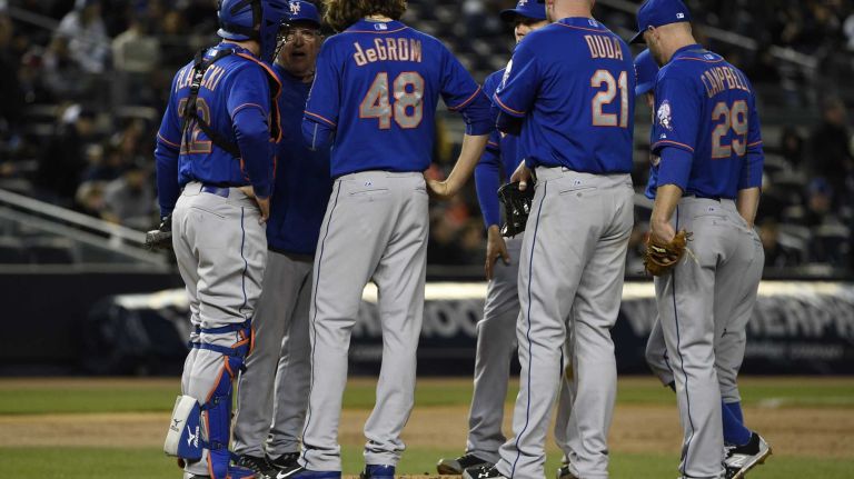 New York Mets pitching coach Dan Warthen talks to New York Mets starting pitcher Jacob deGrom in a baseball game against the New York Yankees at Yankee Stadium on Friday, April 24, 2015.