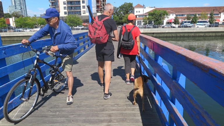 The footbridge is a novelty for New Yorkers used to sidewalks and metal bridges.