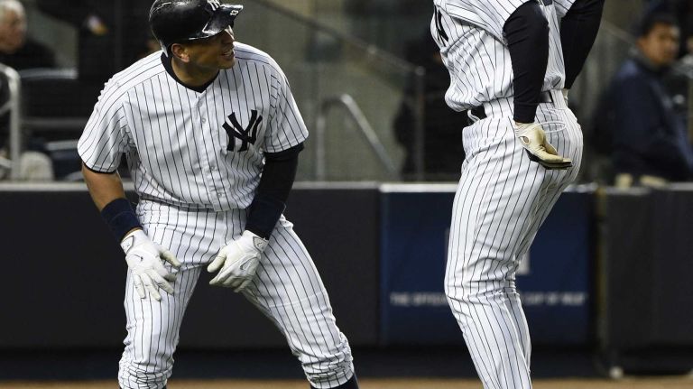 New York Yankees designated hitter Alex Rodriguez and New York Yankees first baseman Mark Teixeira celebrate after Teixeira's two-run home run in the third inning against the New York Mets in a baseball game at Yankee Stadium on Friday, April 24, 2015.