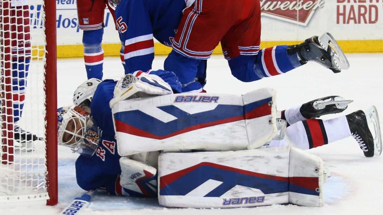 NEW YORK, NY - APRIL 09: Henrik Lundqvist #30 of the New York Rangers shows the effects of being interferered with by Mika Zibanejad #93 of the Ottawa Senators during the first period at Madison Square Garden on April 9, 2015 in New York City. (Photo by Bruce Bennett/Getty Images)