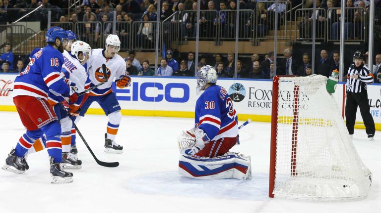 Henrik Lundqvist of the New York Rangers looks on after surrendering a second period goal against Anders Lee of the New York Islanders at Madison Square Garden on Tuesday, Jan. 13, 2015.