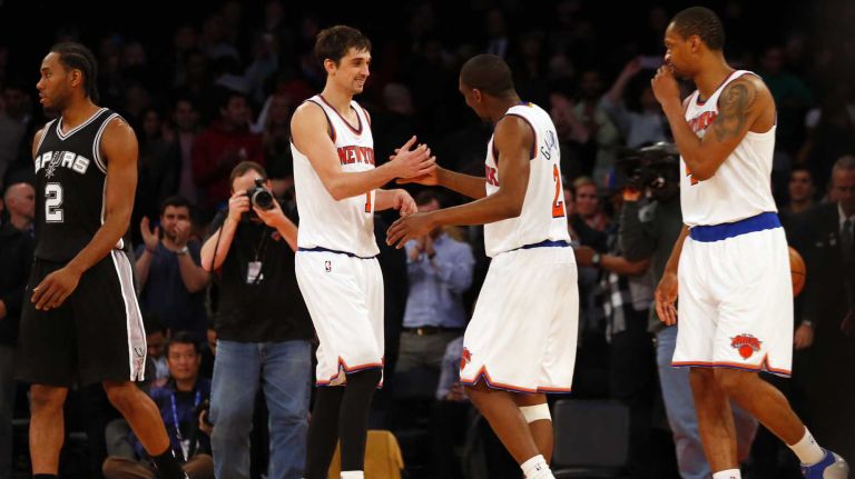 Alexey Shved, Langston Galloway and Lance Thomas of the New York Knicks celebrate after defeating the San Antonio Spurs at Madison Square Garden on Tuesday, March 17, 2015.