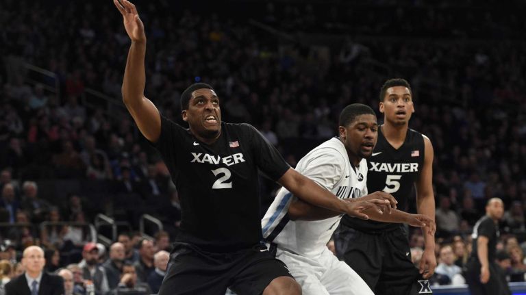 Xavier Musketeers forward James Farr looks for a rebound against Villanova Wildcats forward Kris Jenkins during the final game of the Big East basketball tournament at Madison Square Garden on Saturday, March 14, 2015.