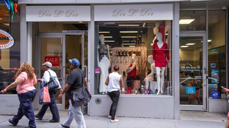 Pedestrians pass boutique Dor L' Dor in Manhattan's Financial District on Aug. 20, 2015.