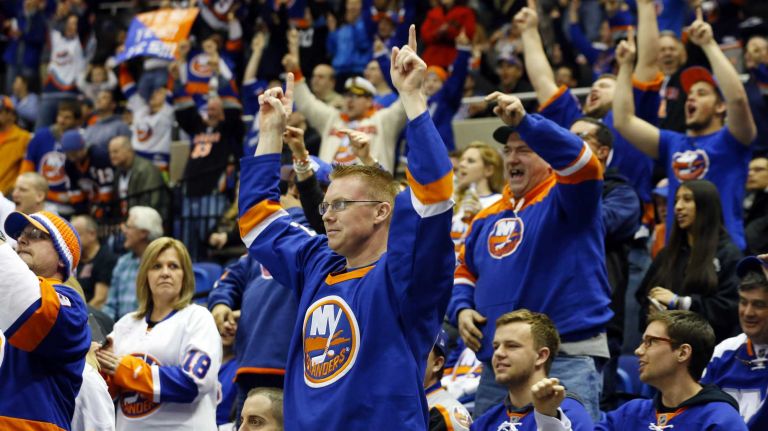 New York Islanders fans celebrate a third period goal against the Ottawa Senators at Nassau Coliseum on Friday, March 13, 2015.