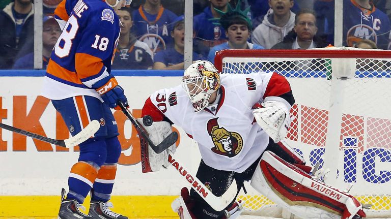Andrew Hammond of the Ottawa Senators makes a save in the second period save as Ryan Strome of the New York Islanders looks for a rebound at Nassau Coliseum on Friday, March 13, 2015.